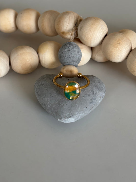 Gold oval ring in forest green