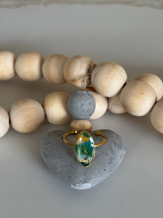 Gold diamond ring in forest green