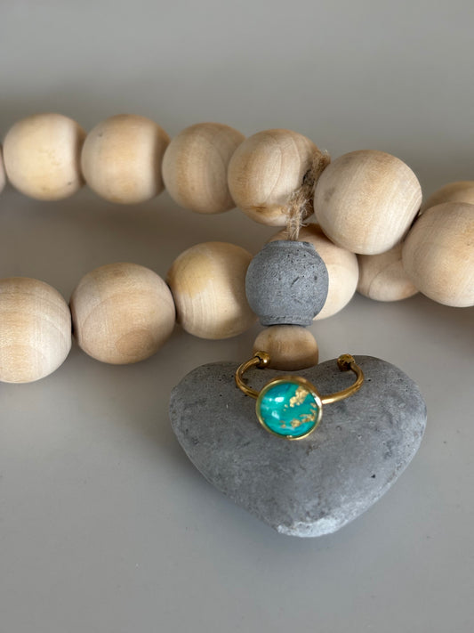 Gold circle ring in teal